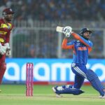 Packed cricket stadium during a T20 World Cup match with bright floodlights and intense crowd atmosphere.