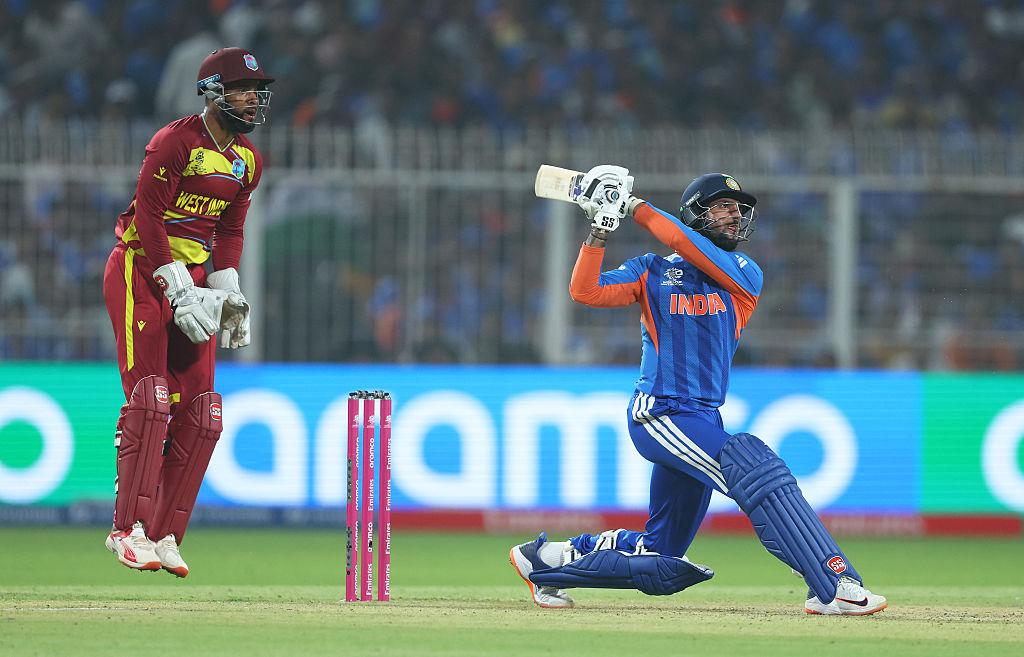 Packed cricket stadium during a T20 World Cup match with bright floodlights and intense crowd atmosphere.