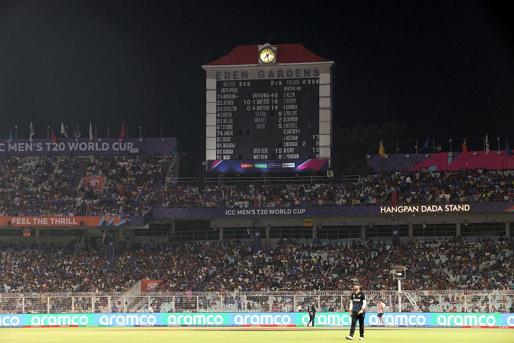 International cricket teams competing in a high-pressure T20 World Cup match under stadium floodlights.