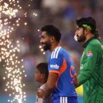 Packed stadium during an India vs Pakistan T20 World Cup match with fans waving flags and cheering.