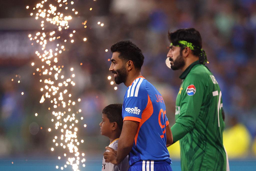 Packed stadium during an India vs Pakistan T20 World Cup match with fans waving flags and cheering.