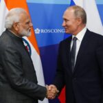 Indian and Russian flags displayed during a diplomatic meeting symbolizing the strategic partnership between the two countries.