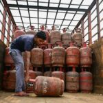 LPG gas cylinders stacked at distribution center during supply pressure in India