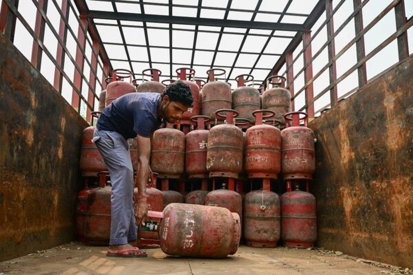LPG gas cylinders stacked at distribution center during supply pressure in India