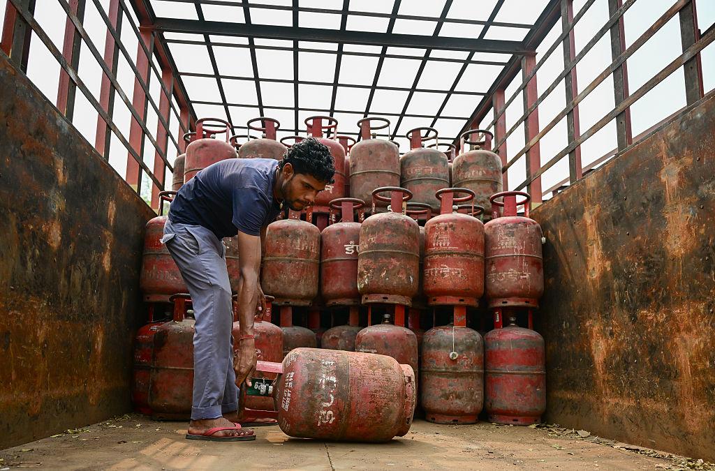 LPG gas cylinders stacked at distribution center during supply pressure in India