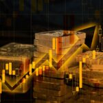 Gold and silver bars placed over a falling financial market chart.