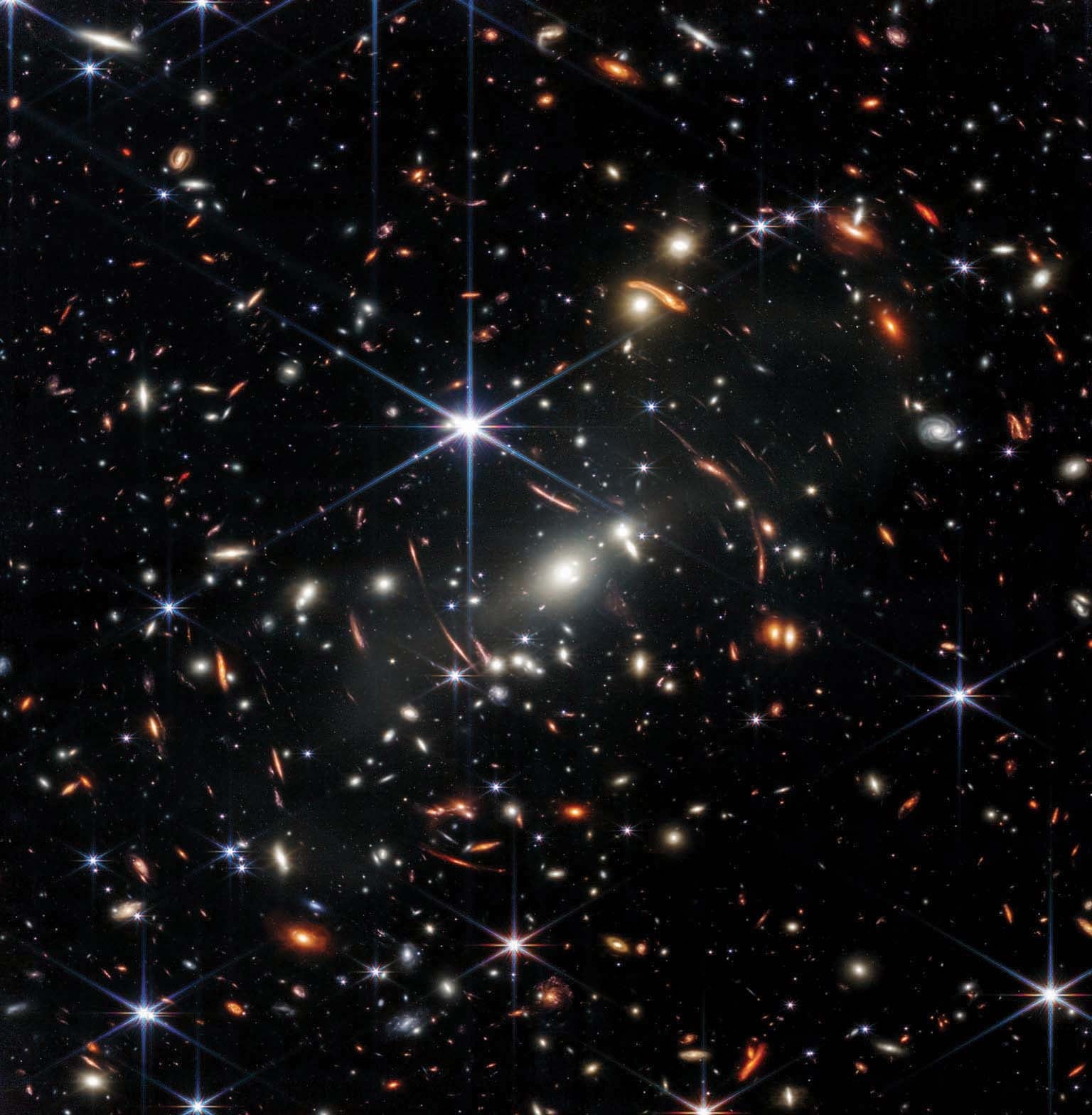 Deep space galaxy cluster captured by the James Webb Space Telescope showing ancient galaxies in infrared light.
