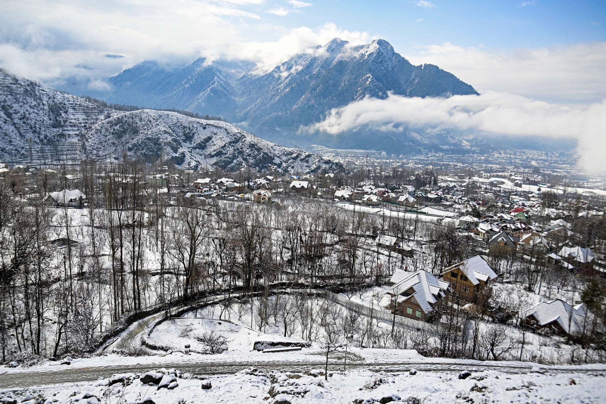 Fresh snowfall in Kashmir and hailstorm conditions in India during unusual March weather.