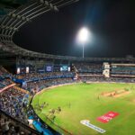 IPL cricket match stadium night lights crowd action