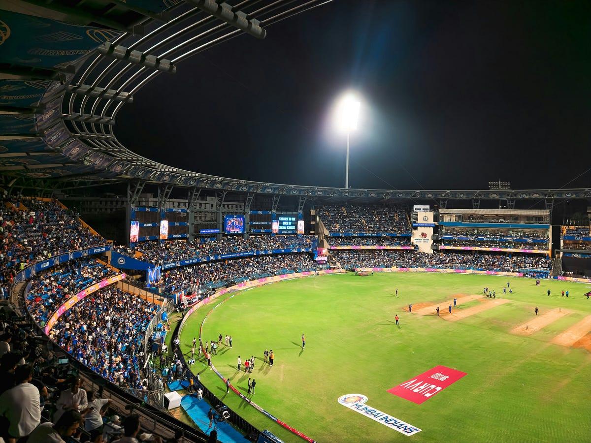 IPL cricket match stadium night lights crowd action